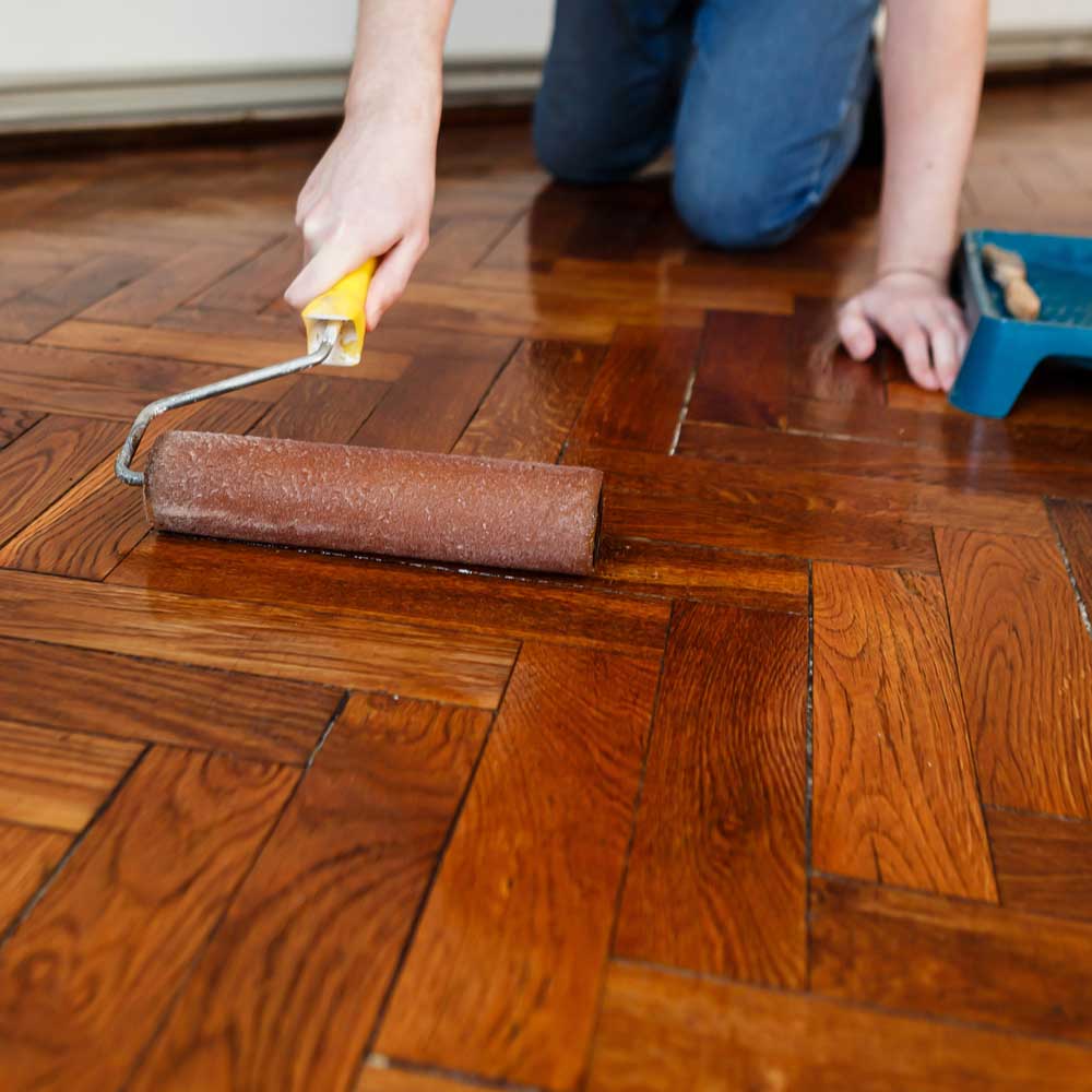 Applying protective coat to hardwood floor